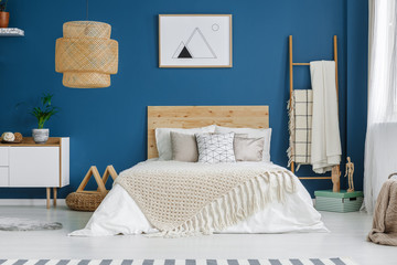 Poster in blue bedroom interior
