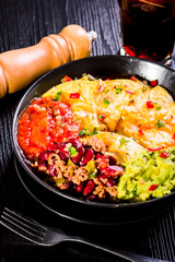 nachos with melted cheese, guacamole and red beans