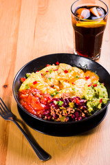 nachos with melted cheese, guacamole and red beans
