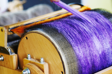 Felting wool. Combing the wool of alpaca or llama before felting on a special machine with a drum...