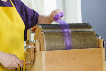 Felting wool. Combing the wool of alpaca or llama before felting on a special machine with a drum...