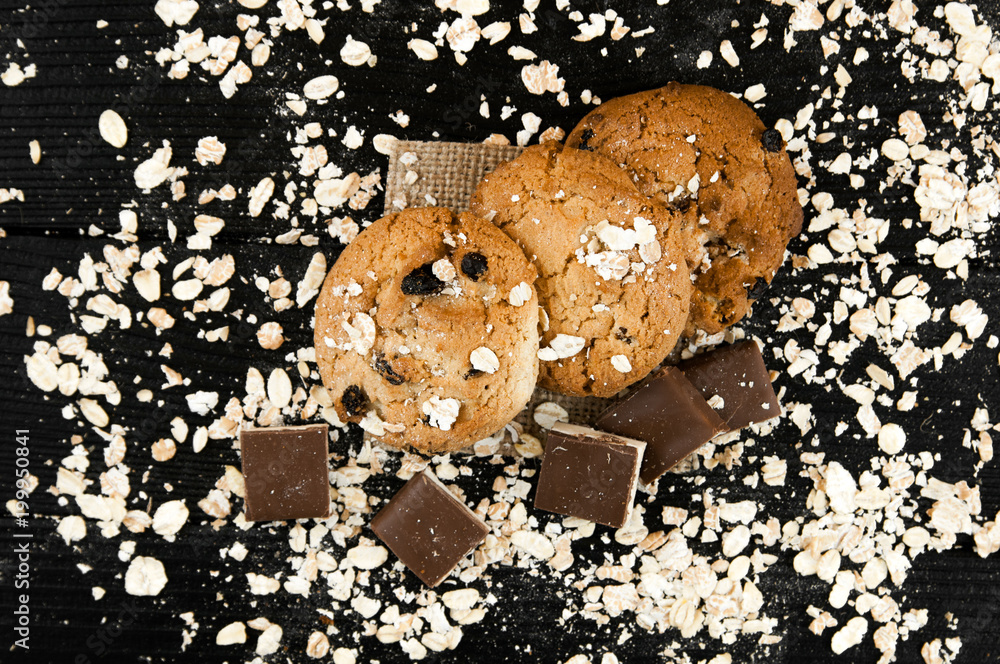 Poster homemade cookies and chocolate on a black vintage table. tasty cookies and biscuits. close-up of coo