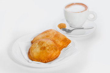 empanadas and coffee for breakfast on a white background