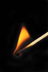 Burning match against black
