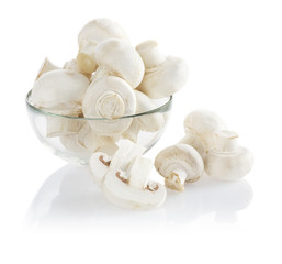 Bunch of mushrooms in a glass bowl isolated on white background
