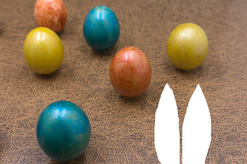 Easter holiday concept with cute handmade eggs, bunny, chicks and party hats .