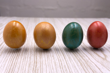 Multi-colored eggs on the nest with orange light side for easter holiday background.