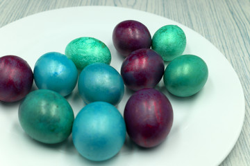 Easter eggs on a blue wooden table .