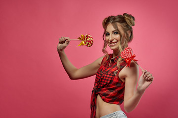 Cheerful young woman with lollipop.