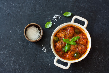 Meatballs and brussel sprouts stewed in tomato sauce