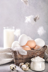 Chicken and quail eggs, flour and milk. Ingredients for cooking. - 199955626