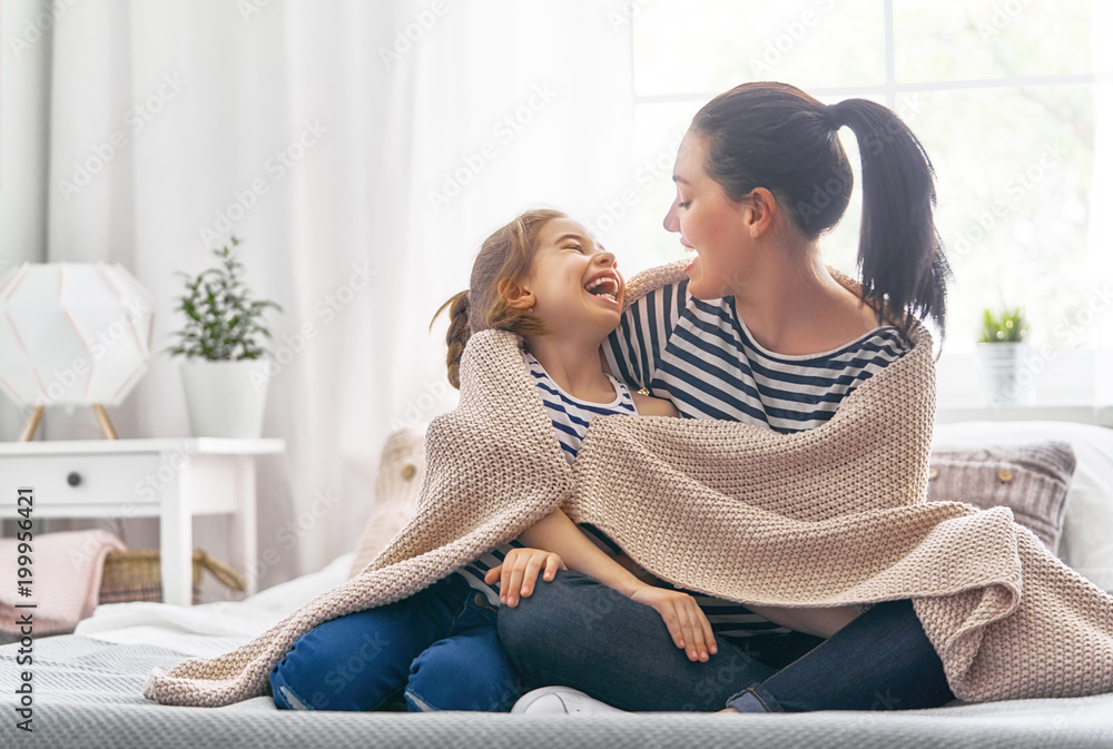 Poster Family playing under blanket