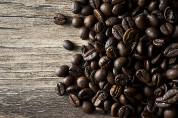 Coffee beans on a wood brown table.