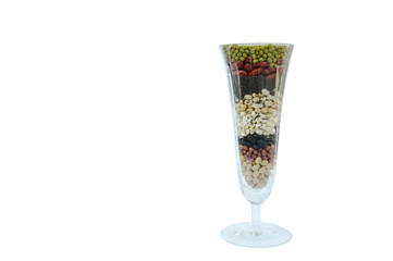 raw variety bean and cereal plant in glass on white background