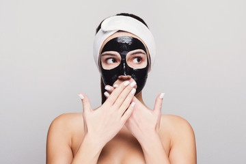 Young girl with purifying black face mask