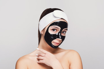 Young girl with purifying black face mask