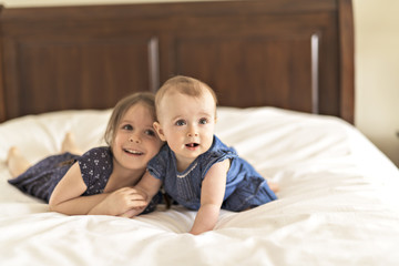 Portrait of brother and sister. Two cute children on bed