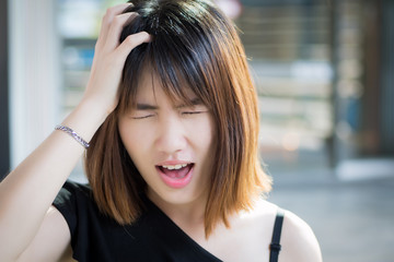 portrait of stressed sick woman screaming with headache; ill woman suffers from vertigo, dizziness,...