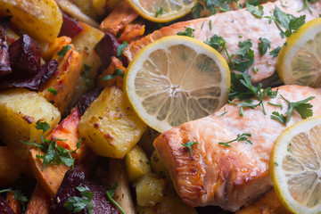 Fototapeta na wymiar salmon baked with vegetables in oven