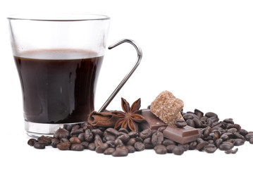 big cup of coffee in coffee beans, anise star, chocolate and sugar  on white background