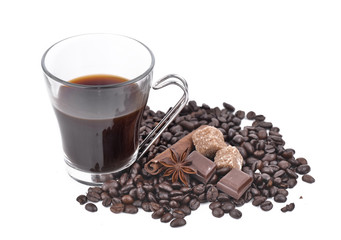 big cup of coffee in coffee beans, anise star, chocolate and sugar  on white background