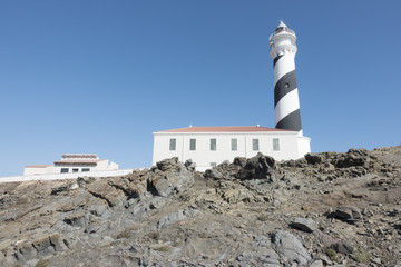 Lighthouse on the slate cape of Favaritx, Menorca, Balearic Islands, Spain