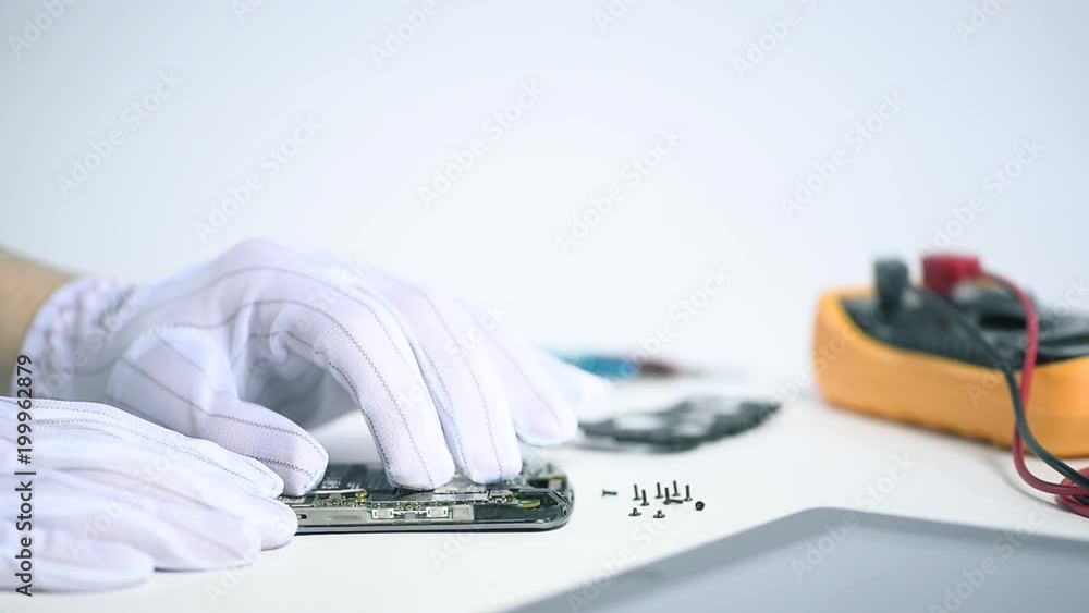 Poster professional it engineer connecting a motherboard on a broken smartphone with care in a high-tech wo
