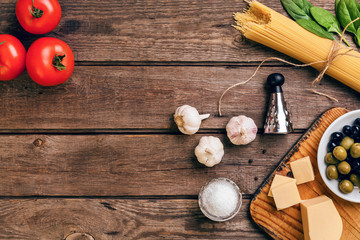 Italian food background with pasta, spices and vegetables. Top view, copy space.