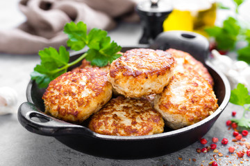 Cutlets. Fried cutlets in cast-iron pan on table