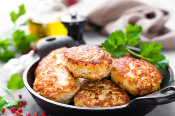 Cutlets. Fried cutlets in cast-iron pan on table