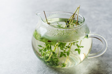 Steaming Herbal Tea in Glass Teapot with  Leaves
