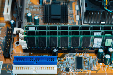 Close-up image of PC computer's motherboard with memory slots installed and with shallow depth of...