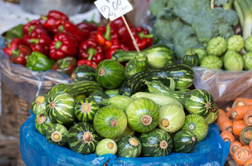 Fresh vegetables piled up at a market vegetable stall