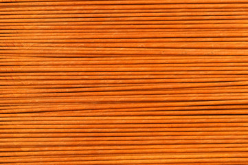 Texture from horizontal paper tubes of beige color for weaving.