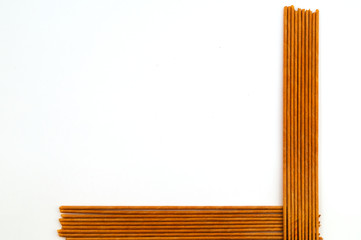 Tubes for weaving from paper, laid perpendicularly in the lower right corner.