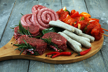 Selection of marinaded meat for bbq grilling with herbs on table