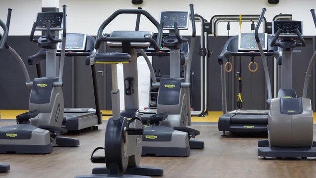 Exercise bikes and treadmills in an empty gym