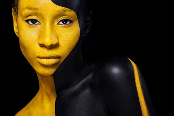 Black and yellow makeup. Cheerful young african woman with art fashion makeup.