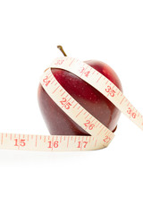 Diet Concept with fresh apple and measuring tape, isolated on white background