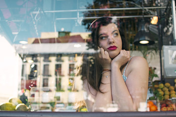 portrait of young woman behind the glass