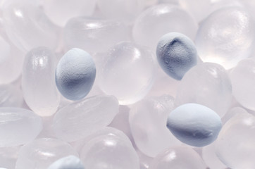 Polypropylene granule with a polymer additive close-up, background texture