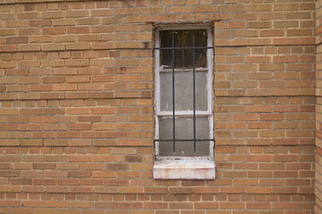 Fototapeta na wymiar Brick Building Window Bars