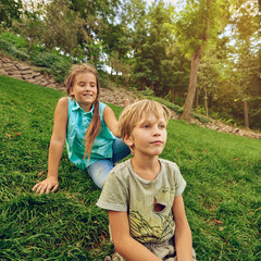Two smiling kids having fun and playing in the park, image with toning square aspect ratio
