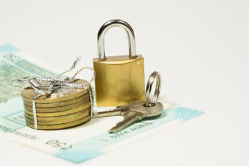 New 50 Rupees Indain Curency and 10 rupee Coins with lock and keys on isolated white background with copy space