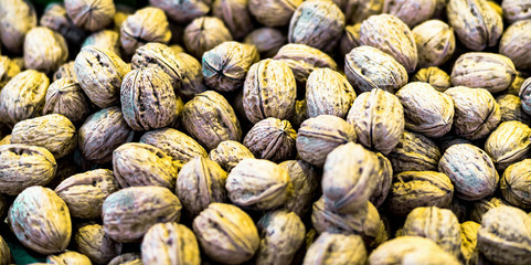 Pile of walnuts in shells background