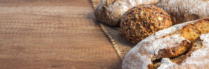 Panoramic wooden kitchen worktop with bread and rolls