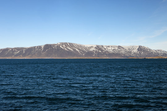 The mountains across the water in Iceland