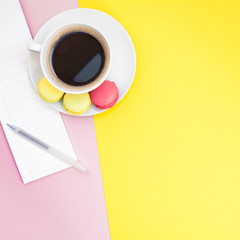 Creative flat lay with coffee cup and macaroons