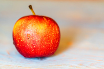 Whole fresh red apple on blue wooden surface