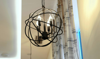 Unusual moderm lamp in the form of a metal ball with four lamps.